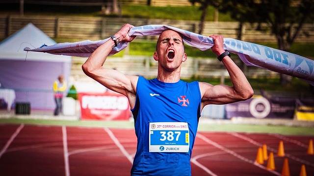 Athlete celebrating victory on track, representing a success story with Zenith Athletic